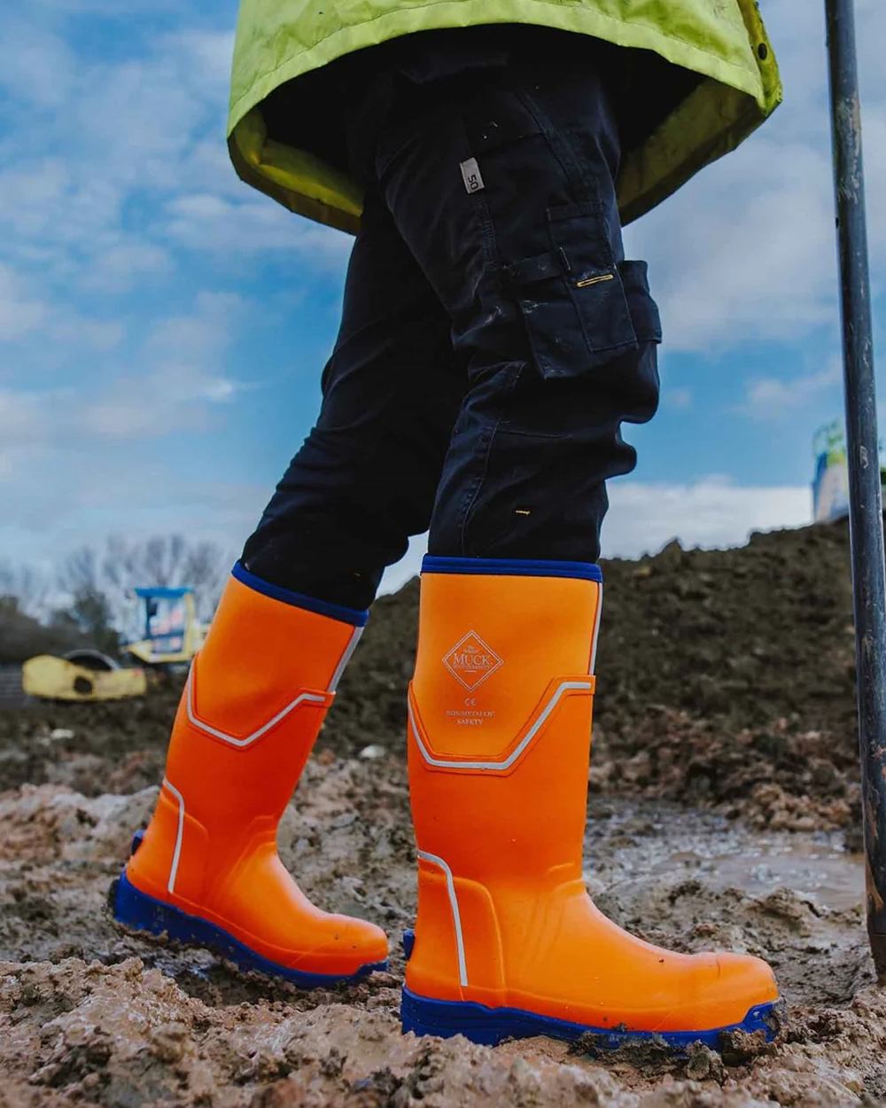 Orange Blue Coloured Muck Boots Mens Grit S5 Tall Boots on Outdoor Background
