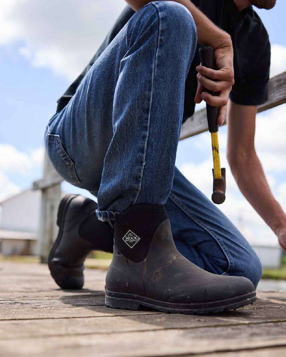 Black Coloured Muck Boots Mens Originals Excursion Ankle Boots on Outdoor Background
