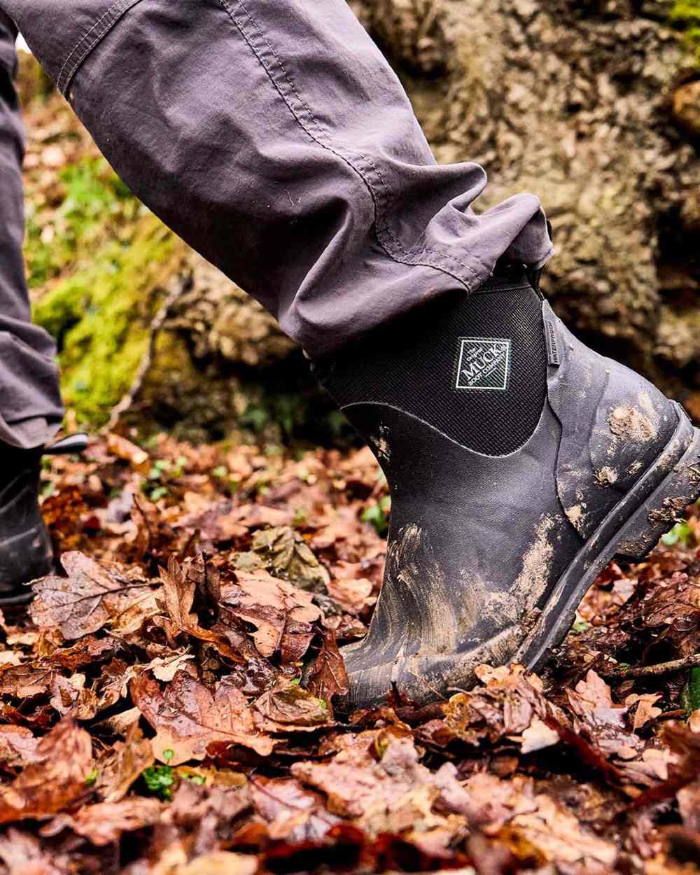 Grey Coloured Muck Boots Mens Originals Excursion Ankle Boots on Outdoor Background
