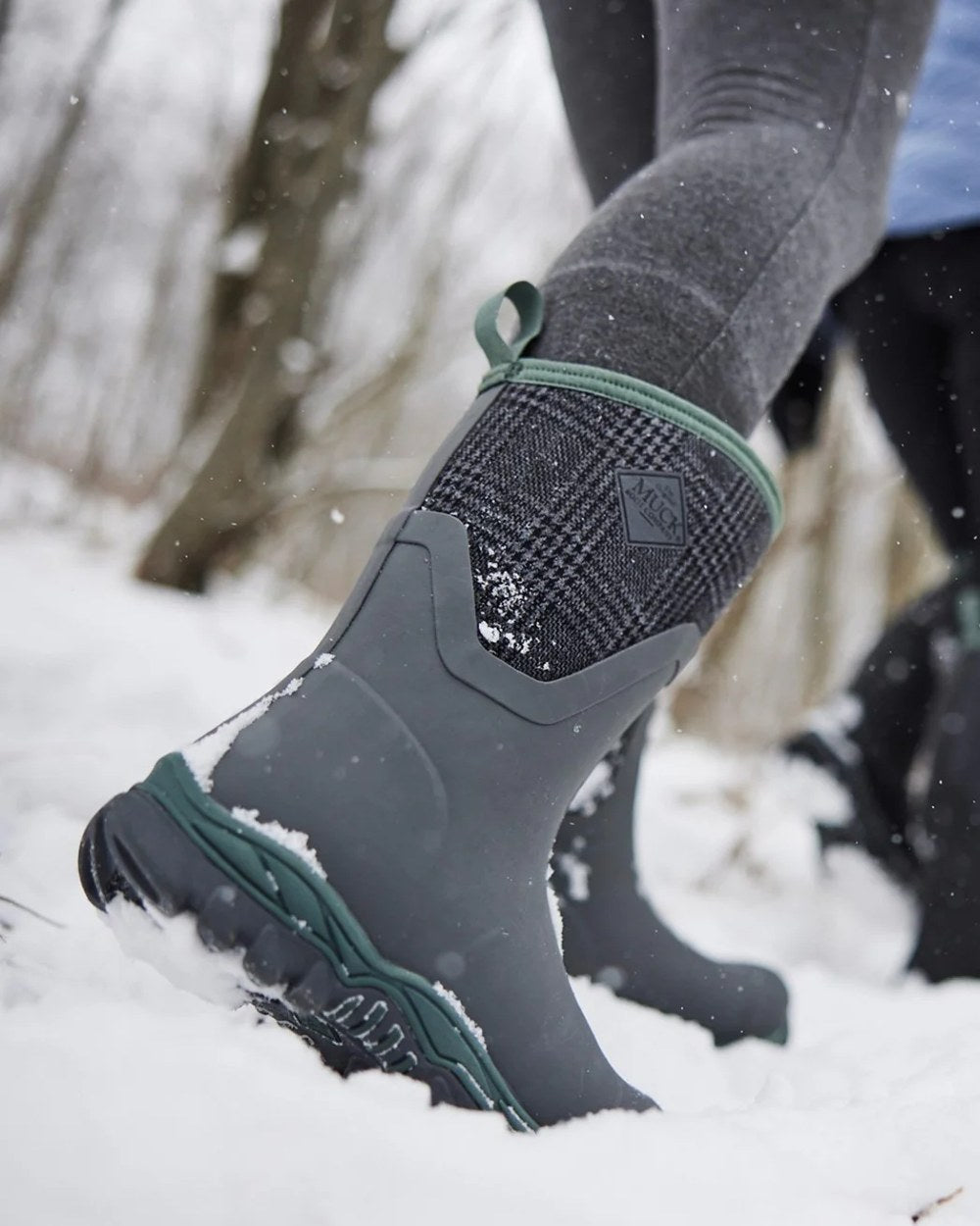 Grey Plaid Print Coloured Muck Boots Womens Arctic Sport II Mid Wellingtons On A Snow Background 