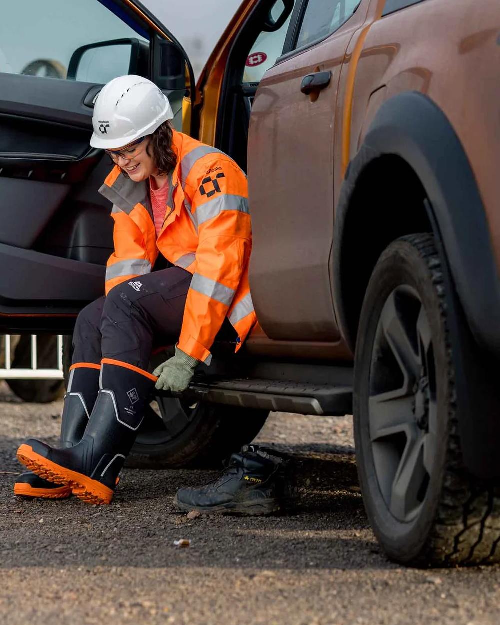 Black Orange Coloured Muck Boots Womens Grit S5 Tall Boots on Outdoor Background
