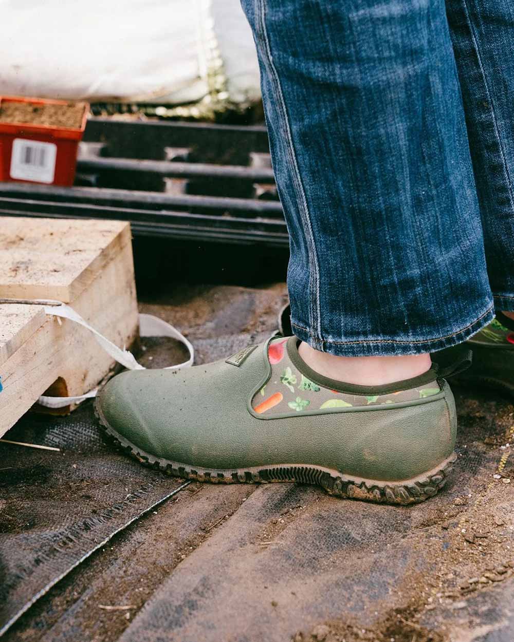 Green Veggie Print coloured Muck Boots Womens RHS Muckster II Low Shoes on Garden background 