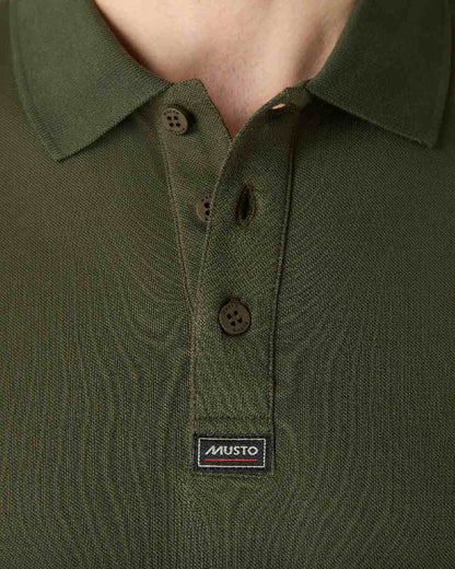 Deep Green coloured Musto Essential Pique Polo Shirt on White background 
