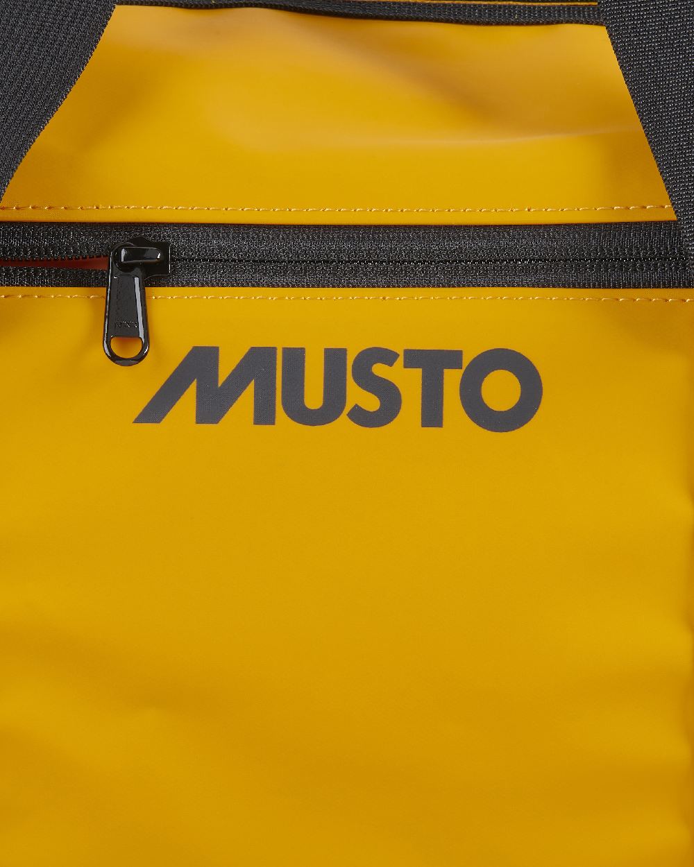 Gold Coloured Musto Genoa Small Carryall on White Background
