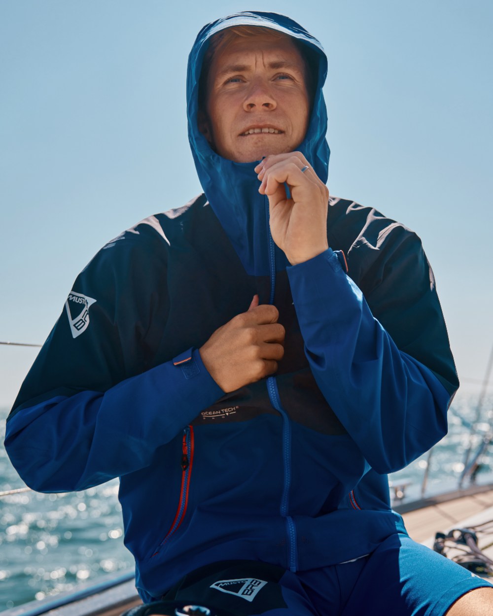 Mazarine Blue Coloured Musto Mens Br3 Sport Jacket on Sea Background
