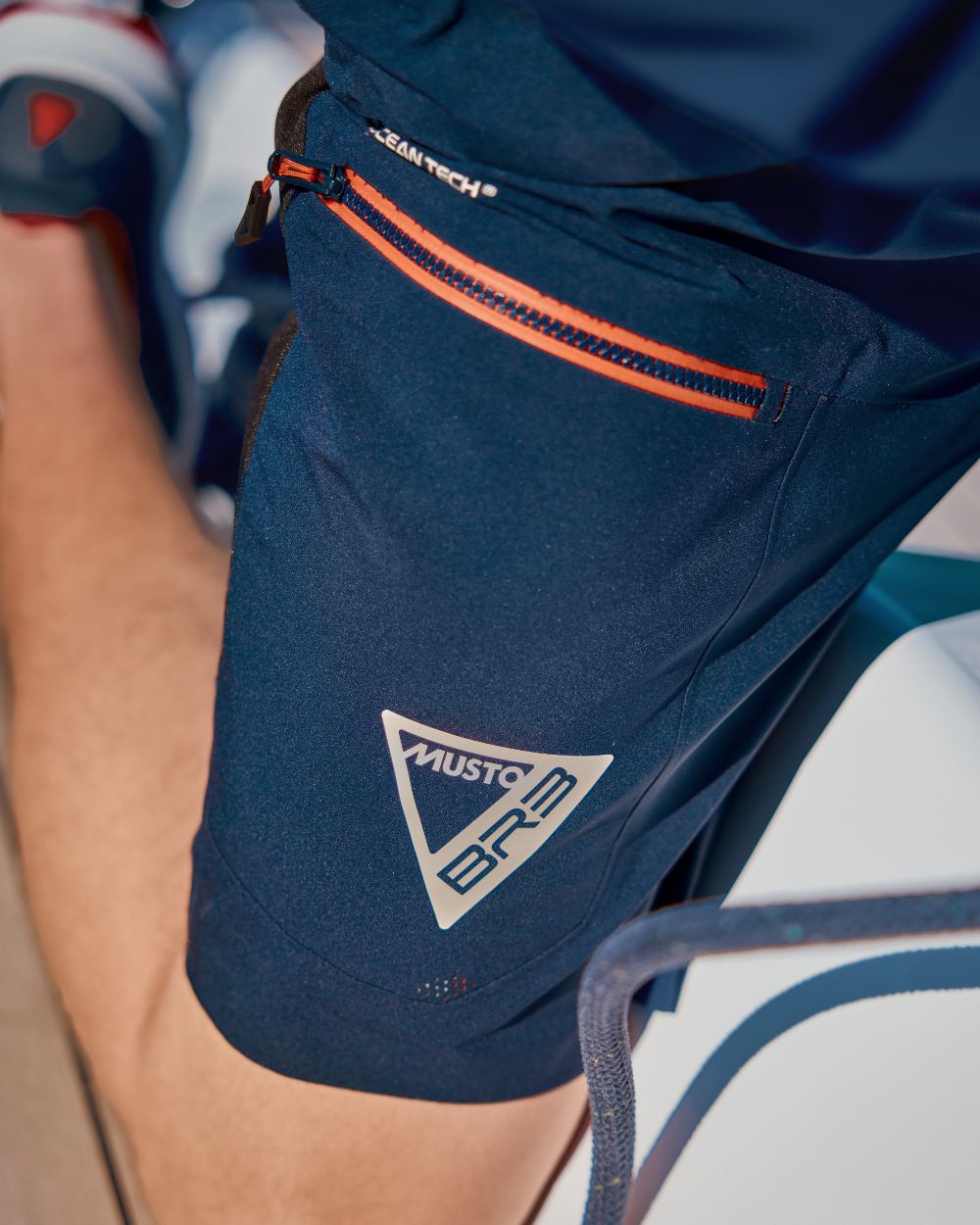 True Navy Coloured Musto Mens Br3 Sport Waterproof Short on Boat Background
