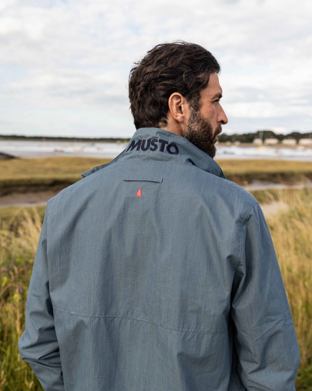 Stormy Weather Coloured Musto Mens Coastal Waterproof Jacket On A Coastal Background 