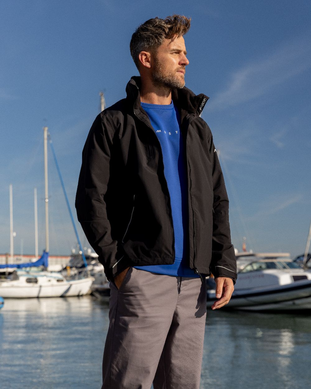 Black Coloured Musto Mens Corsica Jacket on Beach Background

