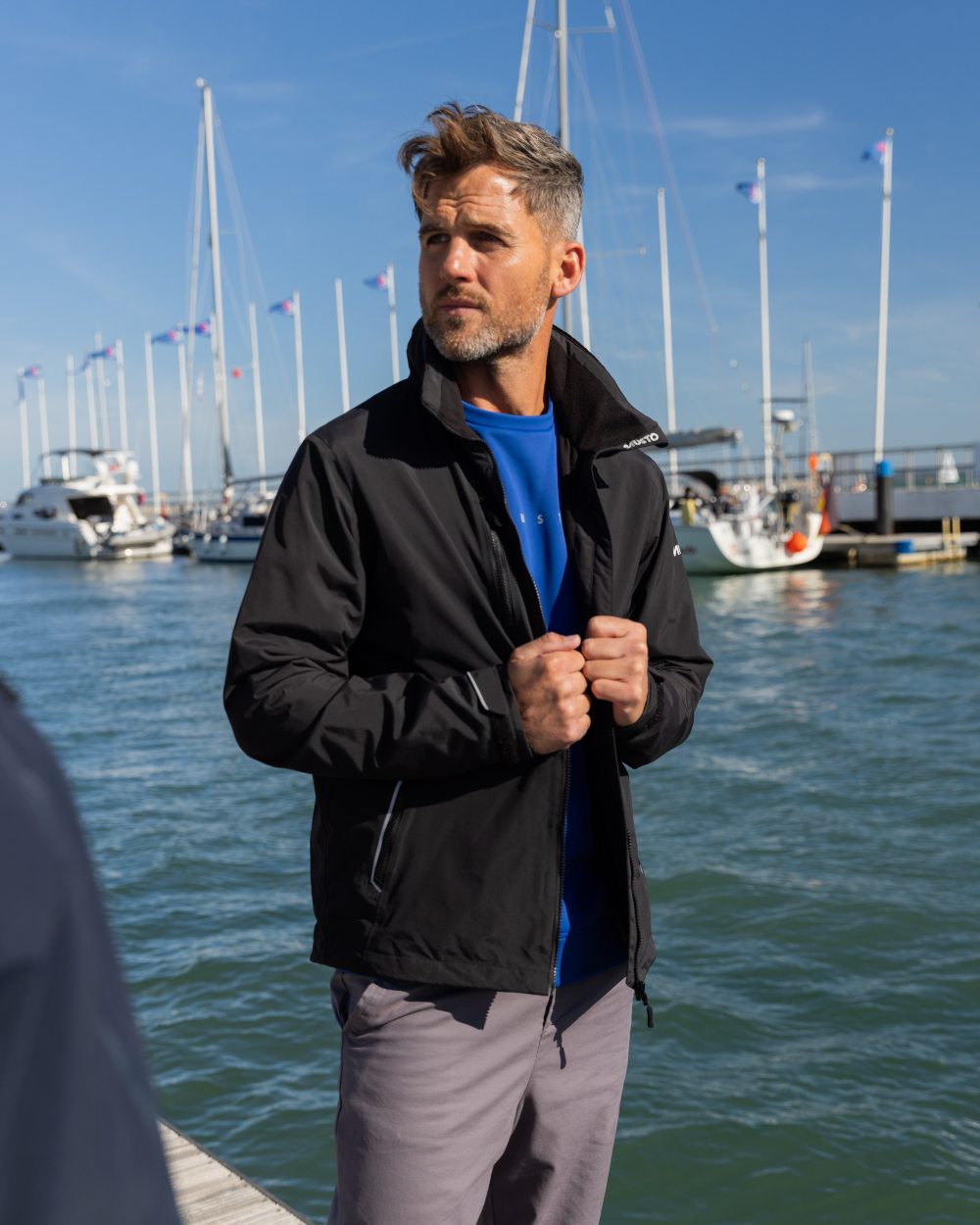 Black Coloured Musto Mens Corsica Jacket on Beach Background
