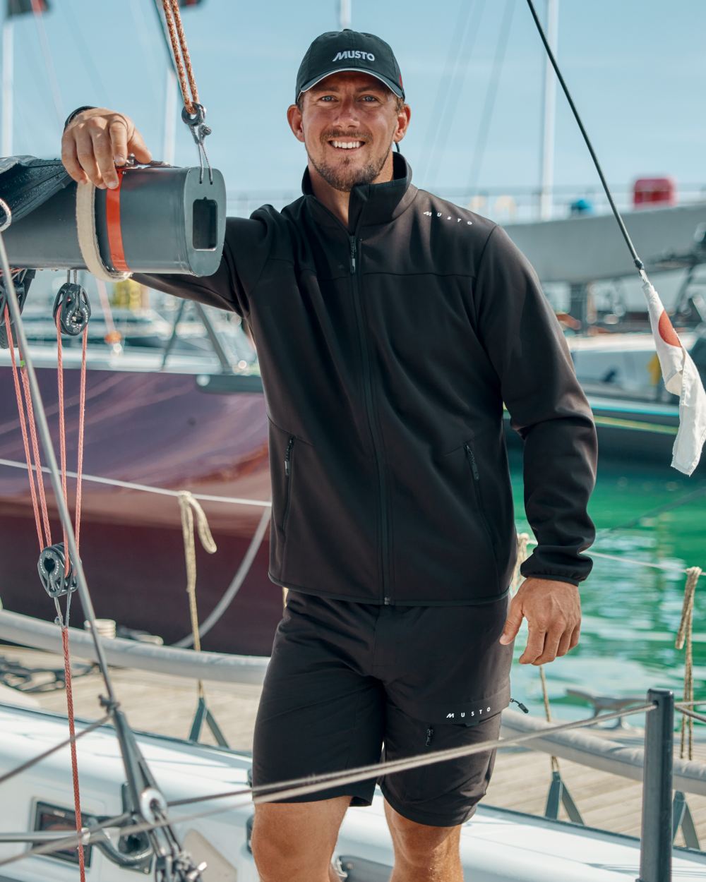 Black Coloured Musto Musto Mens Evo Crew Softshell Jacket on Boat Background
