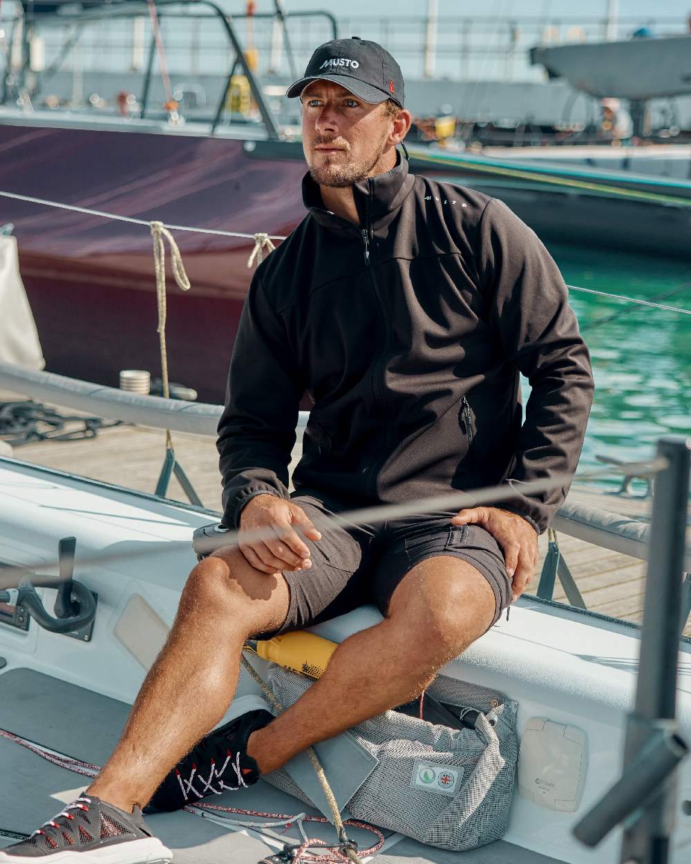 Black Coloured Musto Mens Evo Crew Softshell Jacket on Boat Background
