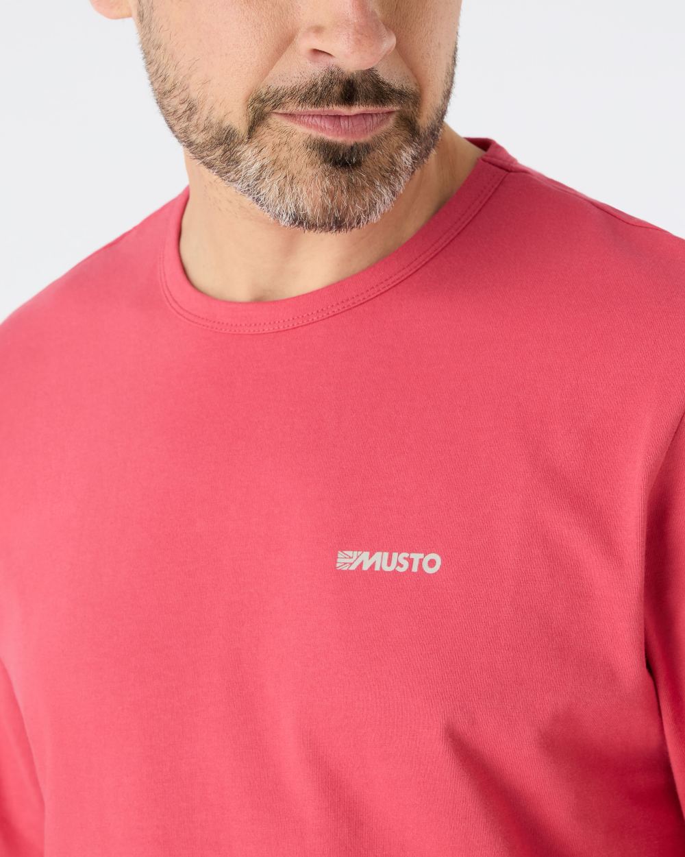 Sweet Raspberry coloured Musto Mens Marina Long Sleeve Logo T-Shirt on grey background 