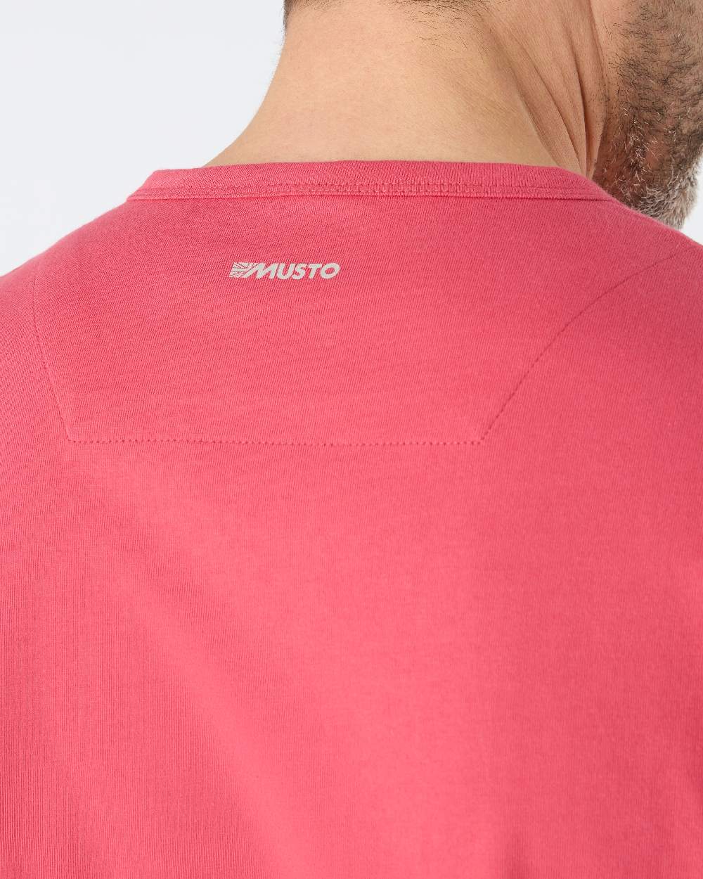 Sweet Raspberry coloured Musto Mens Marina Long Sleeve Logo T-Shirt on grey background 