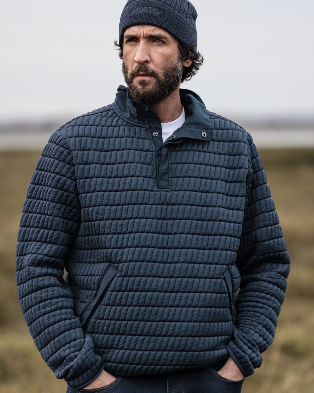Navy Coloured Musto Mens Snug Pullover On A Grass Background 