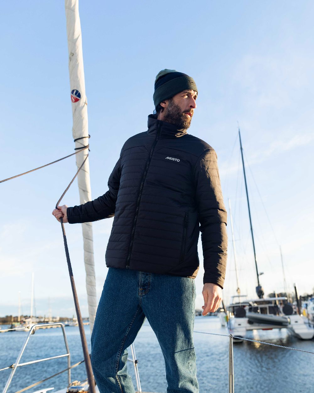Carbon Coloured Musto Mens Solent Primaloft Insulator Jacket on Beach Background
