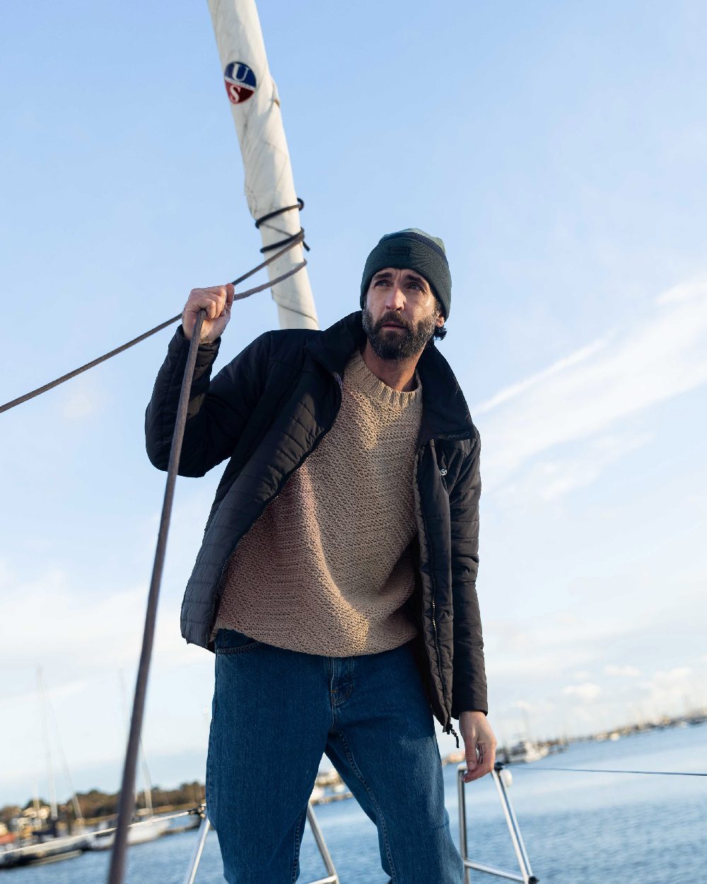 Carbon Coloured Musto Mens Solent Primaloft Insulator Jacket on Beach Background
