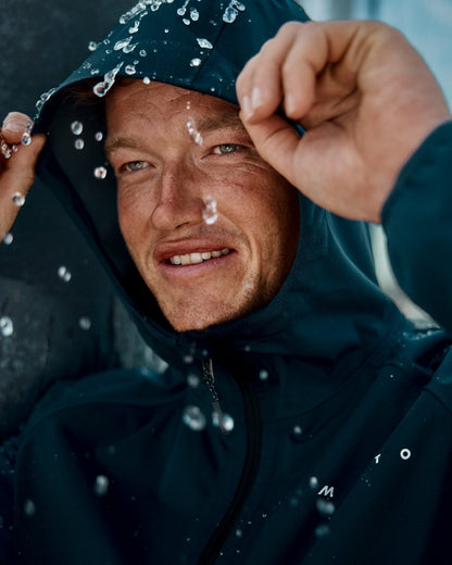 Navy Coloured Musto Mens Venture 3L Jacket on Blurry Background
