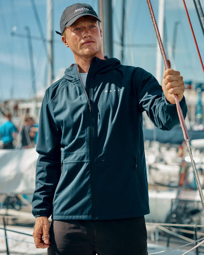 Navy Coloured Musto Mens Venture 3L Jacket on Blurry Background
