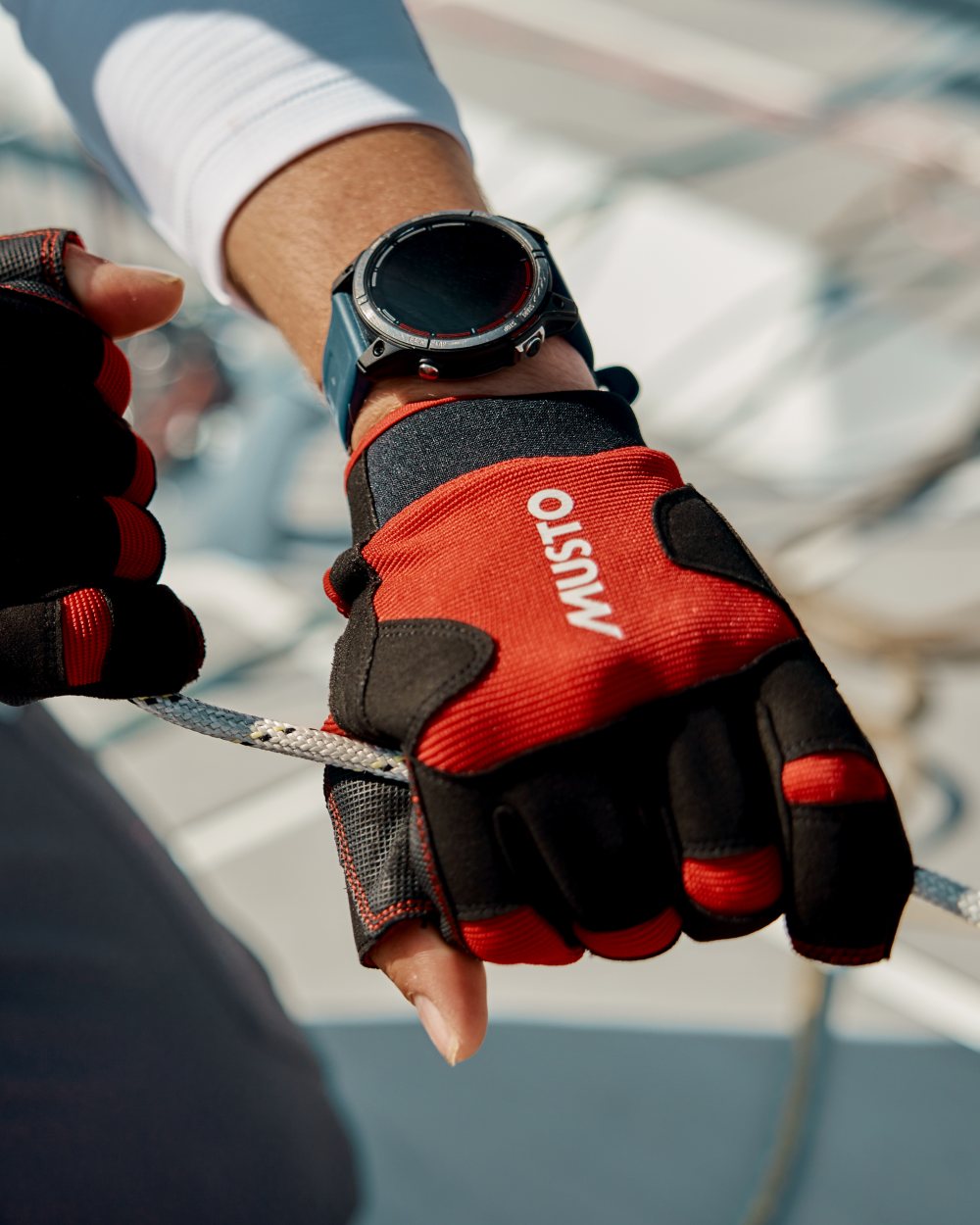 True Red Coloured Musto Performance Short Finger Glove 2.0 on Blurry Background
