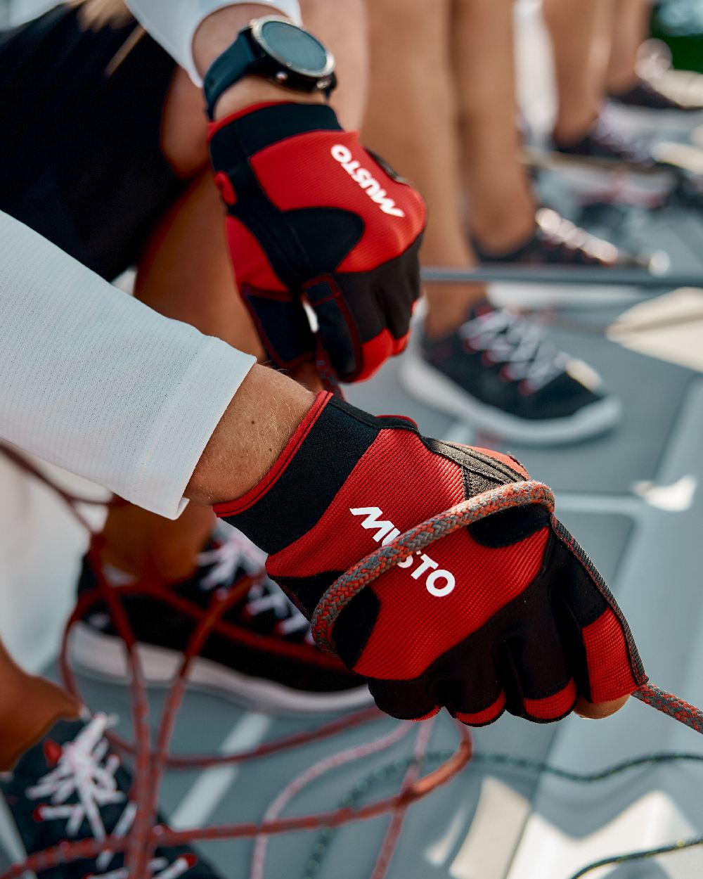 True Red Coloured Musto Performance Short Finger Glove 2.0 on Blurry Background
