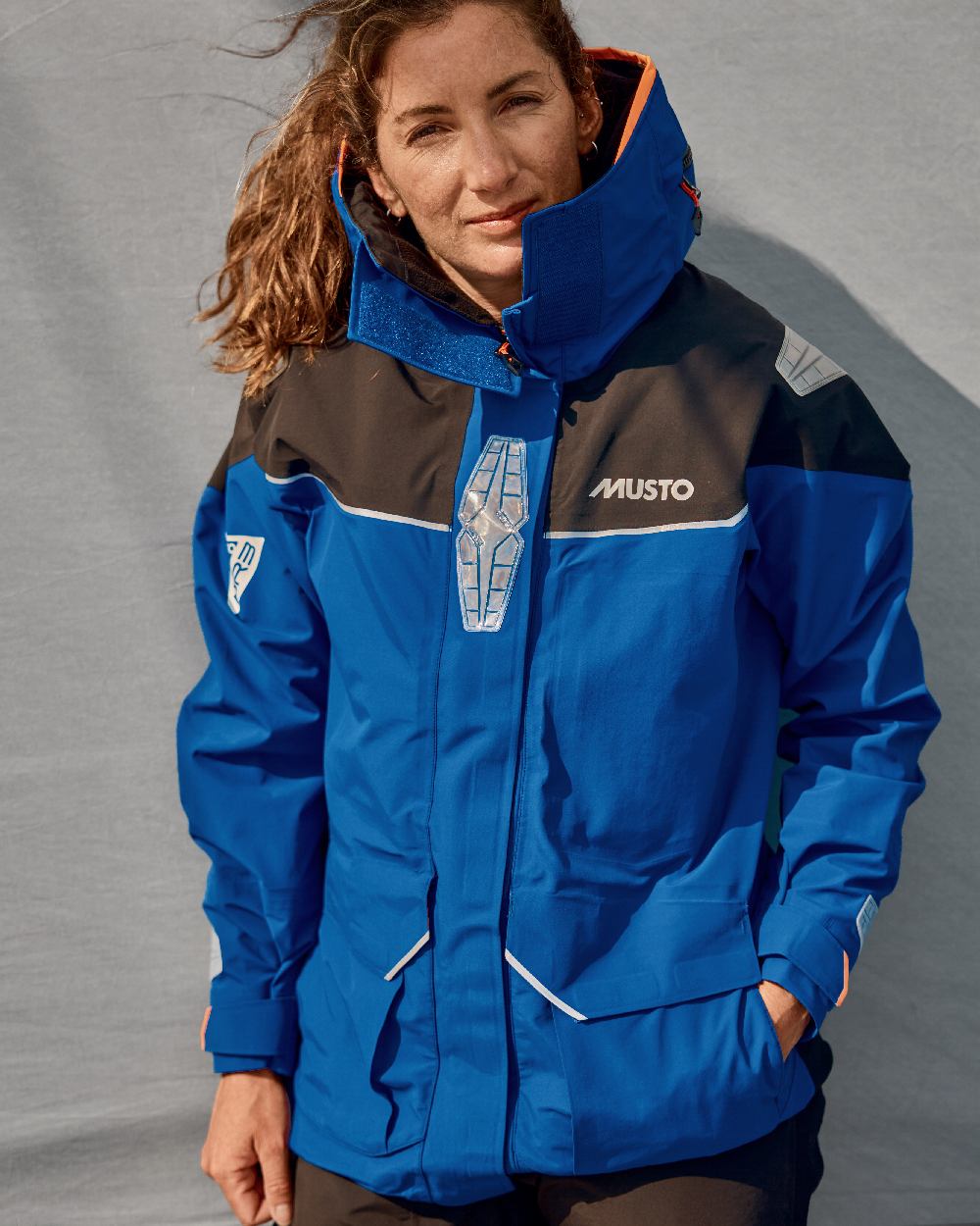 Mazarine Blue Coloured Musto Womens Br3 Pertex Offshore Jacket on Blurry Background
