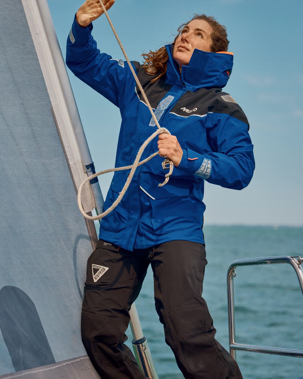 Mazarine Blue Coloured Musto Womens Br3 Pertex Offshore Jacket on sea Background
