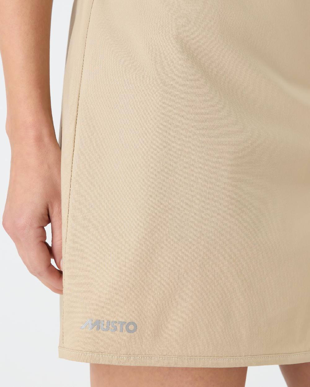 Beige coloured Musto Womens Fast Dry Skorts on grey background 