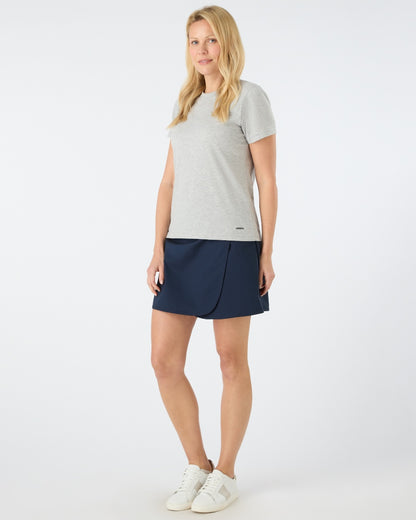 Navy coloured Musto Womens Fast Dry Skorts on grey background 