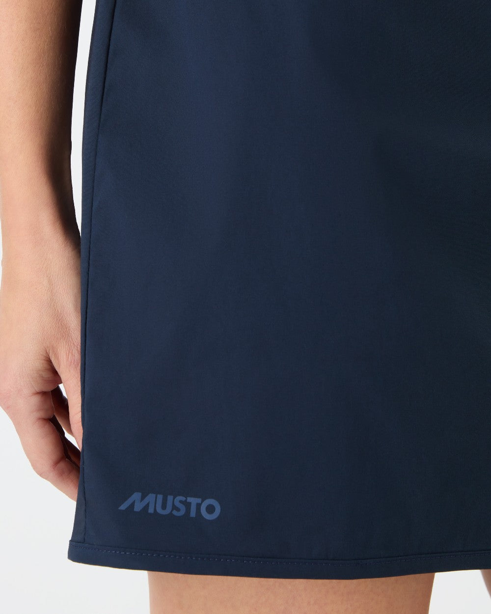 Navy coloured Musto Womens Fast Dry Skorts on grey background 