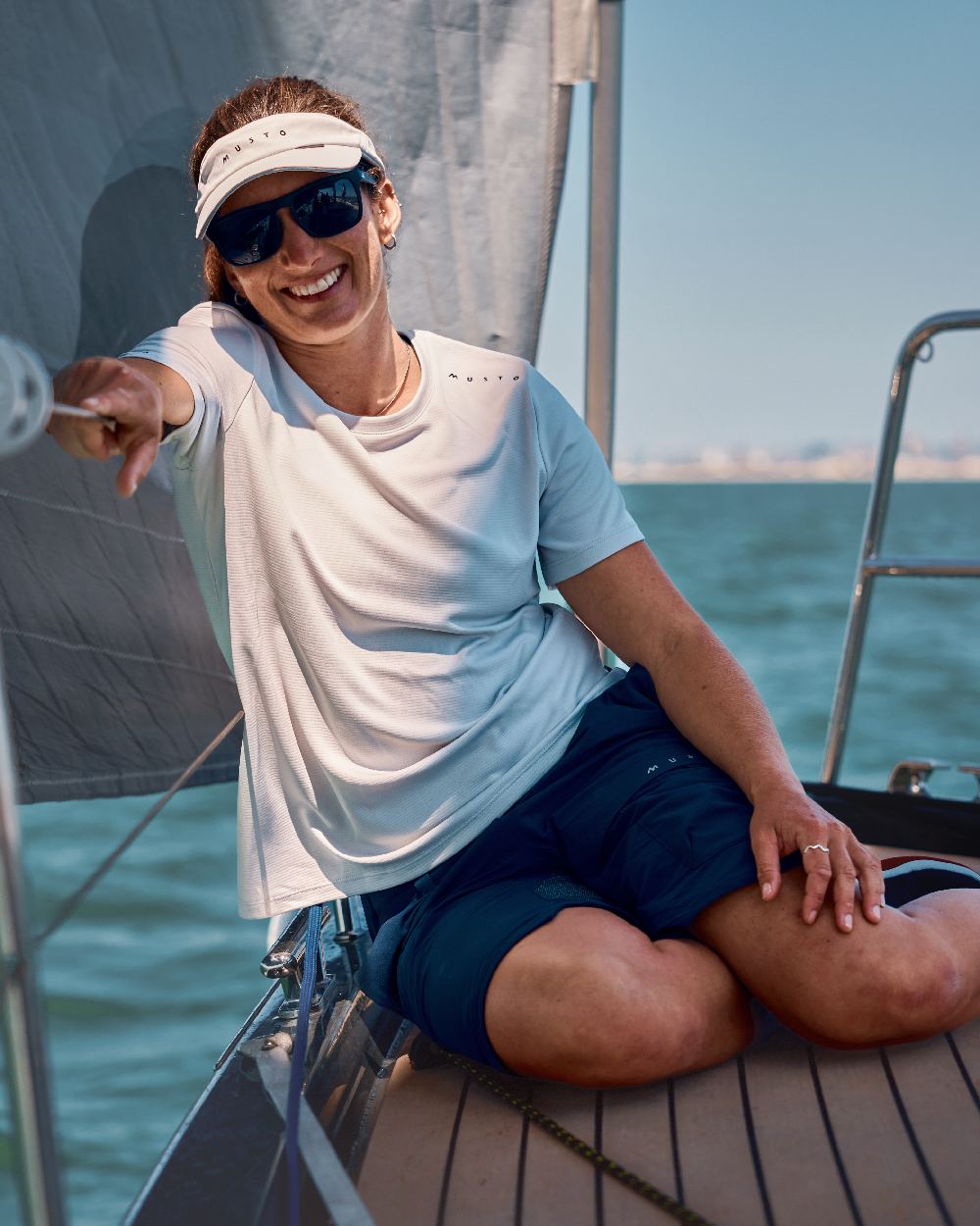 True Navy Coloured Musto Womens Performance Stretch Shorts on Boat Background
