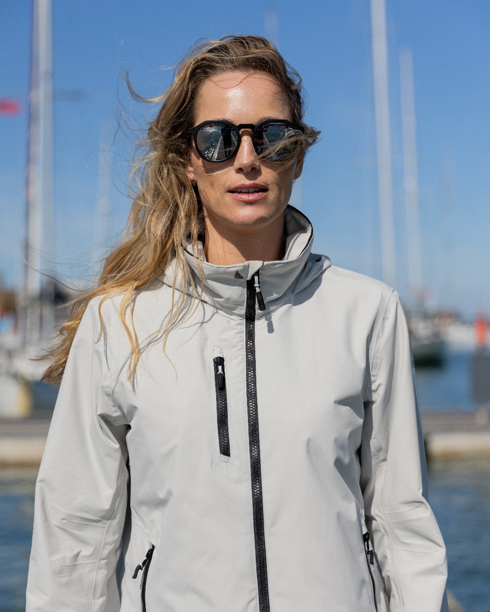 Platinum Coloured Musto Womens Sardinia Jacket on Blurry Background
