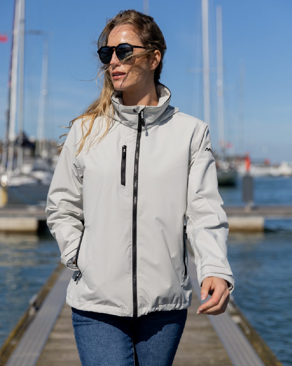 Platinum Coloured Musto Womens Sardinia Jacket on Blurry Background
