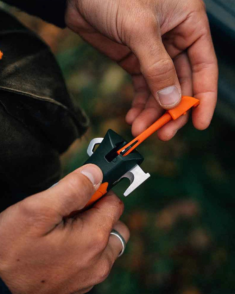 Orange Coloured Opinel No. 12 Explore Knife with Tick Remover On A Forest Background 