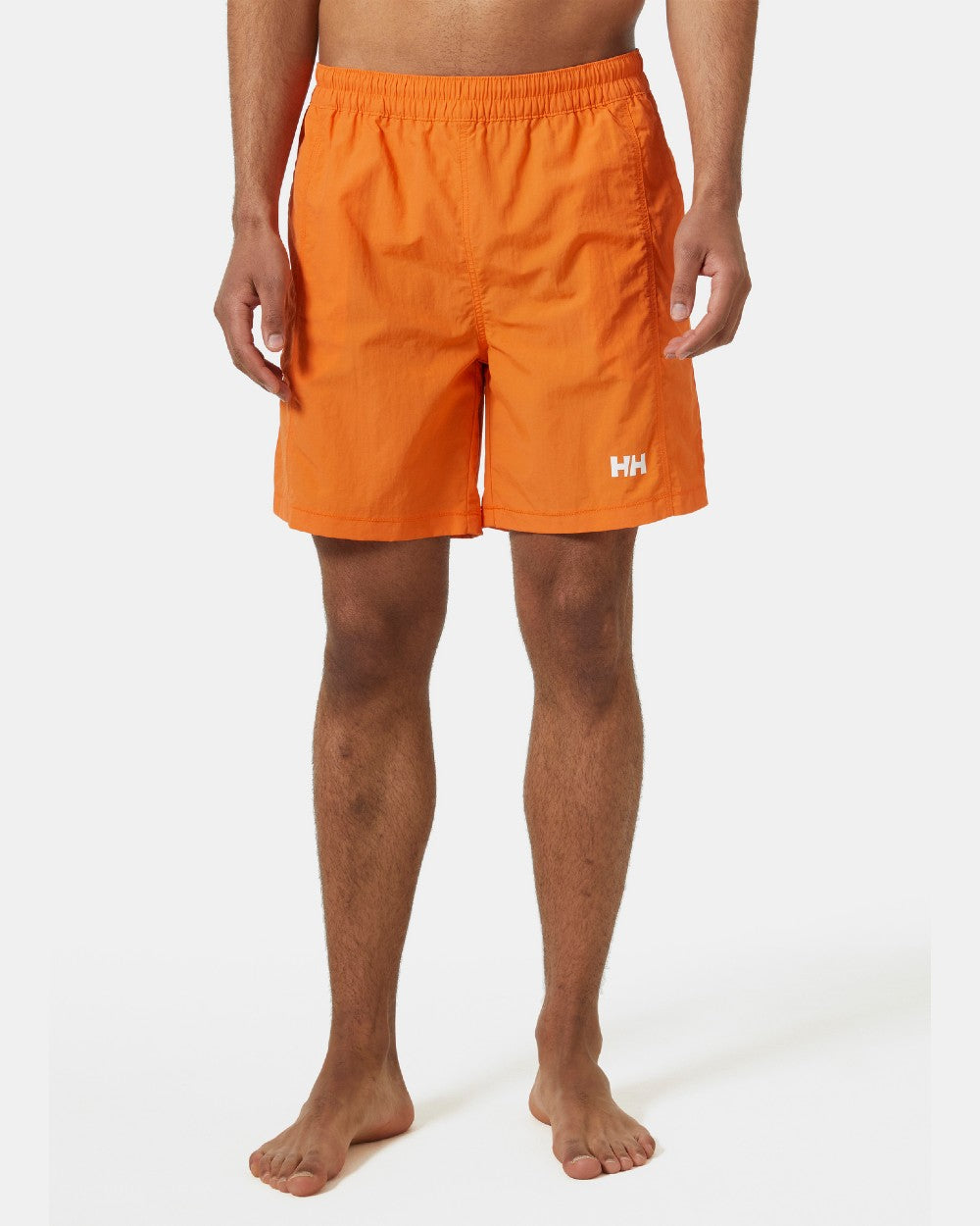 Poppy Orange coloured Helly Hansen Mens Calshot Trunks on a grey background 