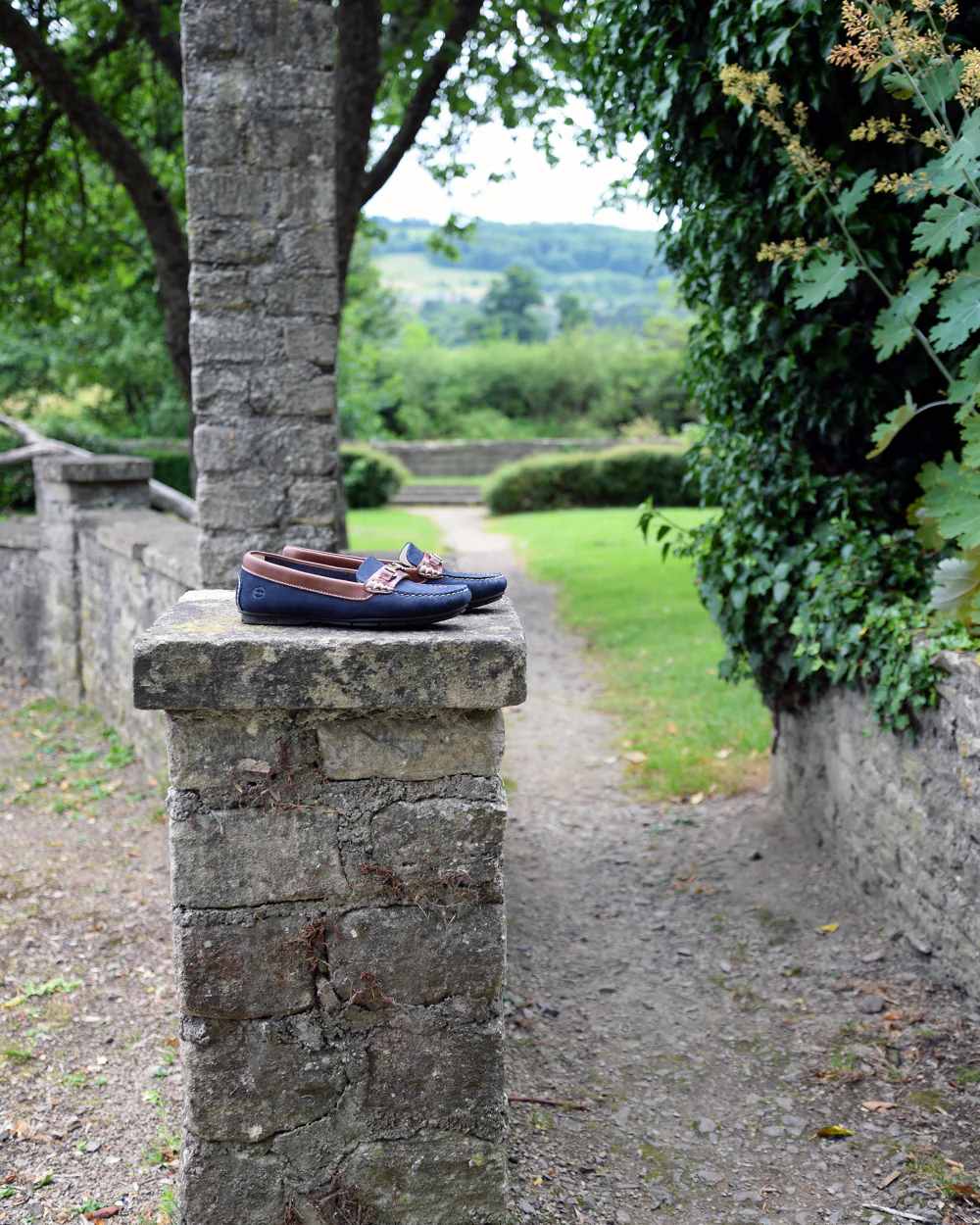 Navy Coloured Orca Bay Verona Womens Loafers On A Garden Background 