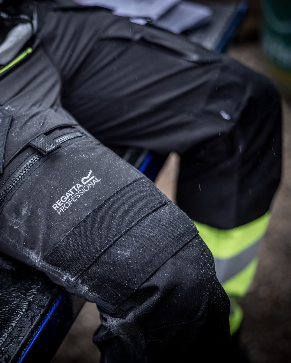 Black Yellow Coloured Regatta Mens Hi-Vis X-Pro Stretch Holster Trousers Class 1 on Blurry Background
