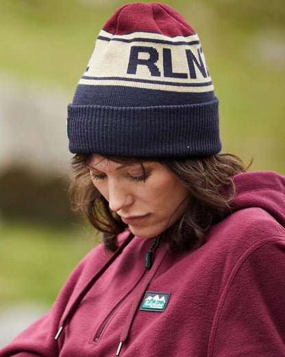 Navy Multi Coloured Ridgeline RLNZ Knitted Beanie On A Blurry Background 