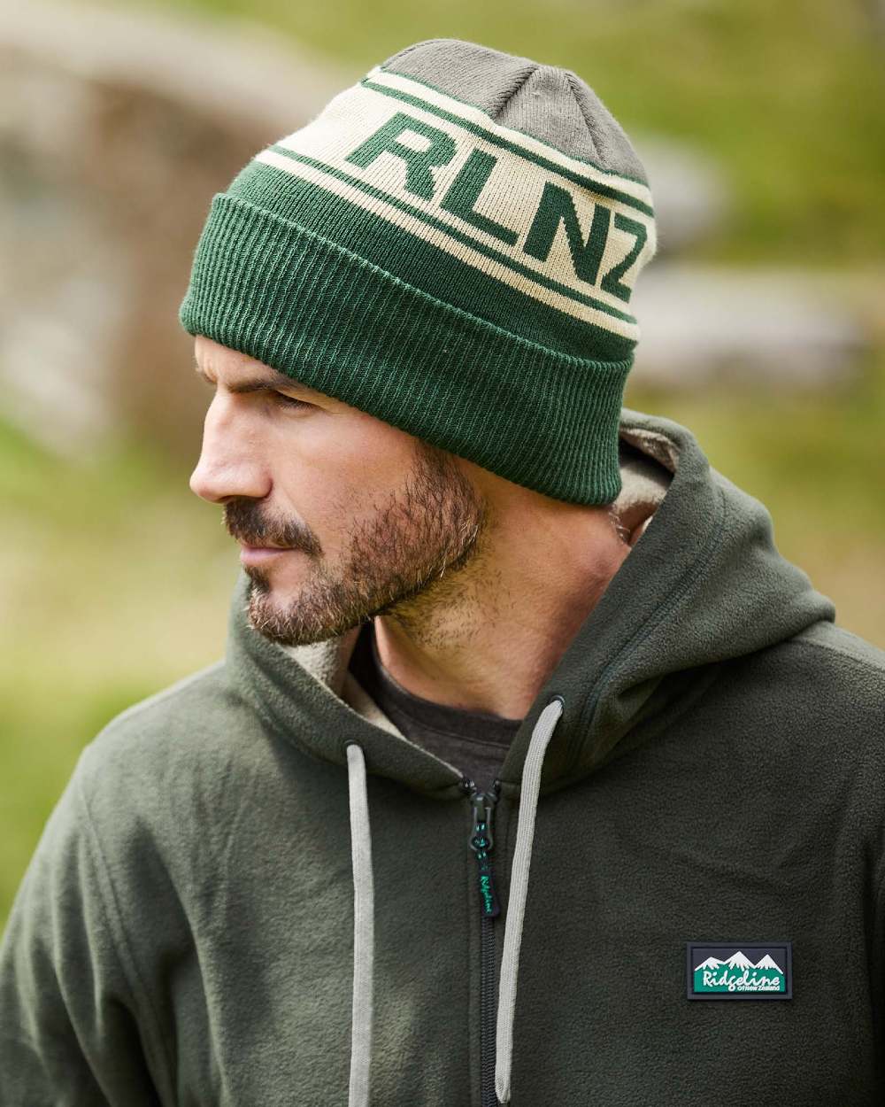 Olive Multi Coloured Ridgeline RLNZ Knitted Beanie on outdoor background 