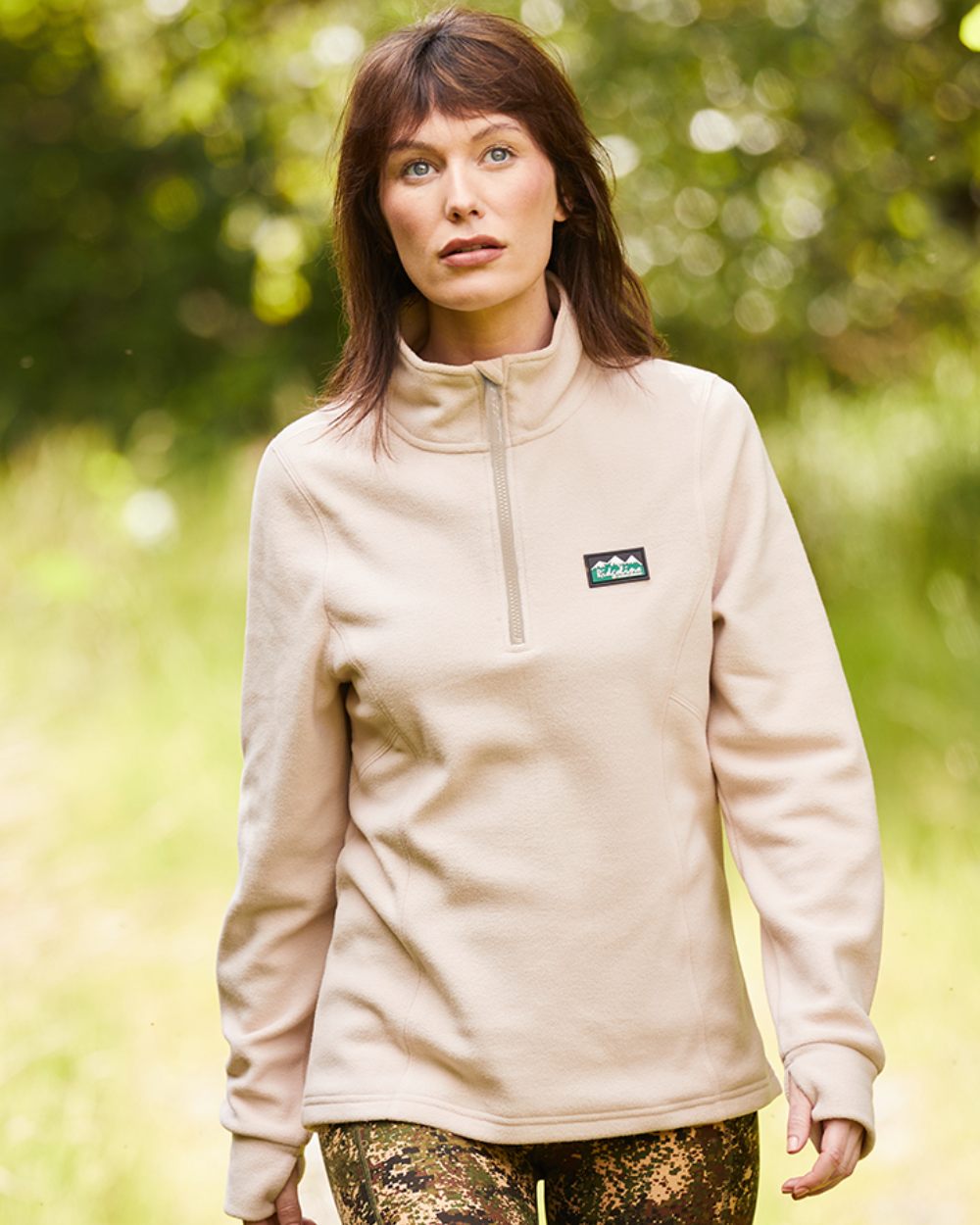 Mushroom Coloured Ridgeline Womens Narvik Fleece On A Blurry Forest Background 