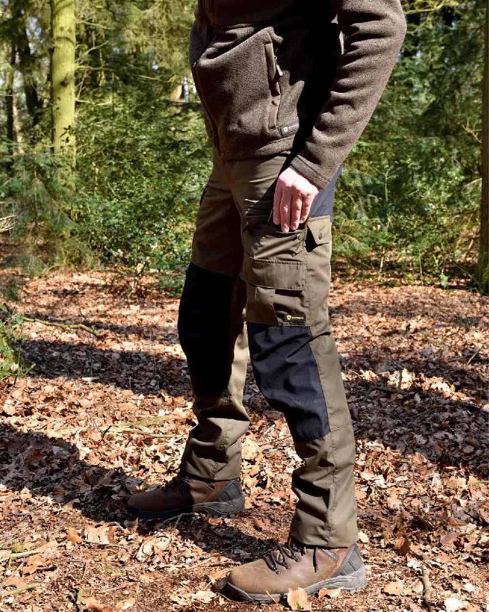 Green/Black coloured Rovince Mens Duofit Trousers on forest background 