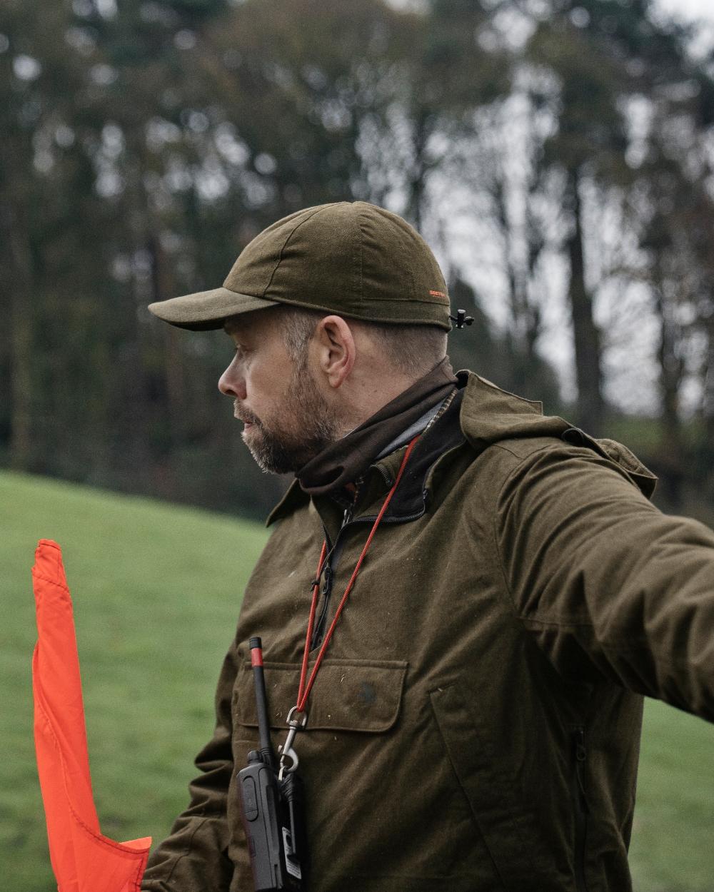 Pine Green Melange Coloured Seeland Avail Cap On A Forest Background