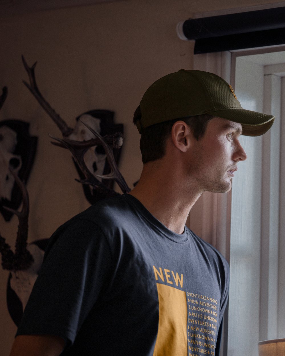 Dark Navy Coloured Seeland Path T-Shirt On A Room Background