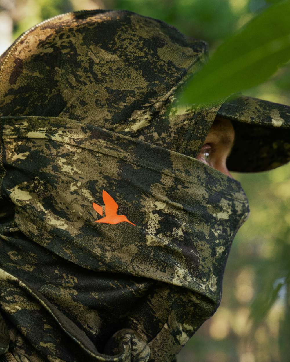 InVis Coloured Seeland Scent Control Camo Balaclava On A Forest Background