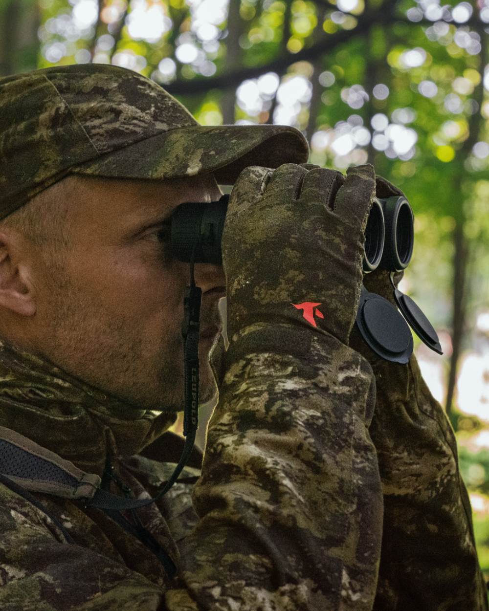 InVis Coloured Seeland Scent Control Camo Balaclava On A Forest Background