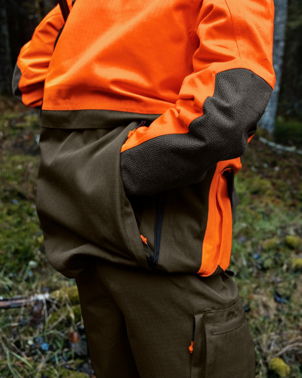 Pine Green/Hi-Vis Orange Coloured Seeland Venture Rover Jacket On A Forest Background