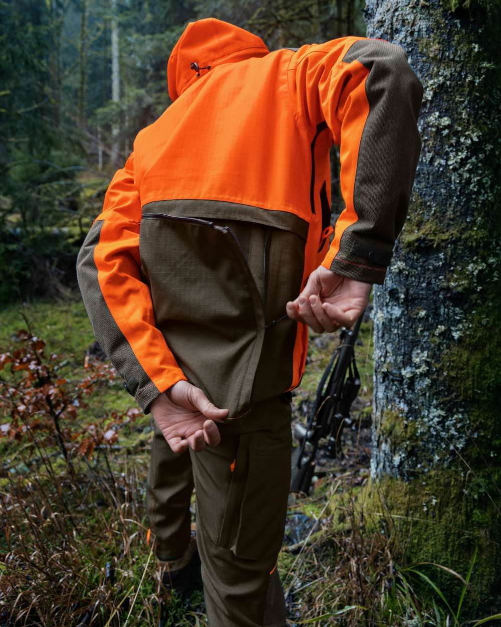 Pine Green/Hi-Vis Orange Coloured Seeland Venture Rover Jacket On A Forest Background