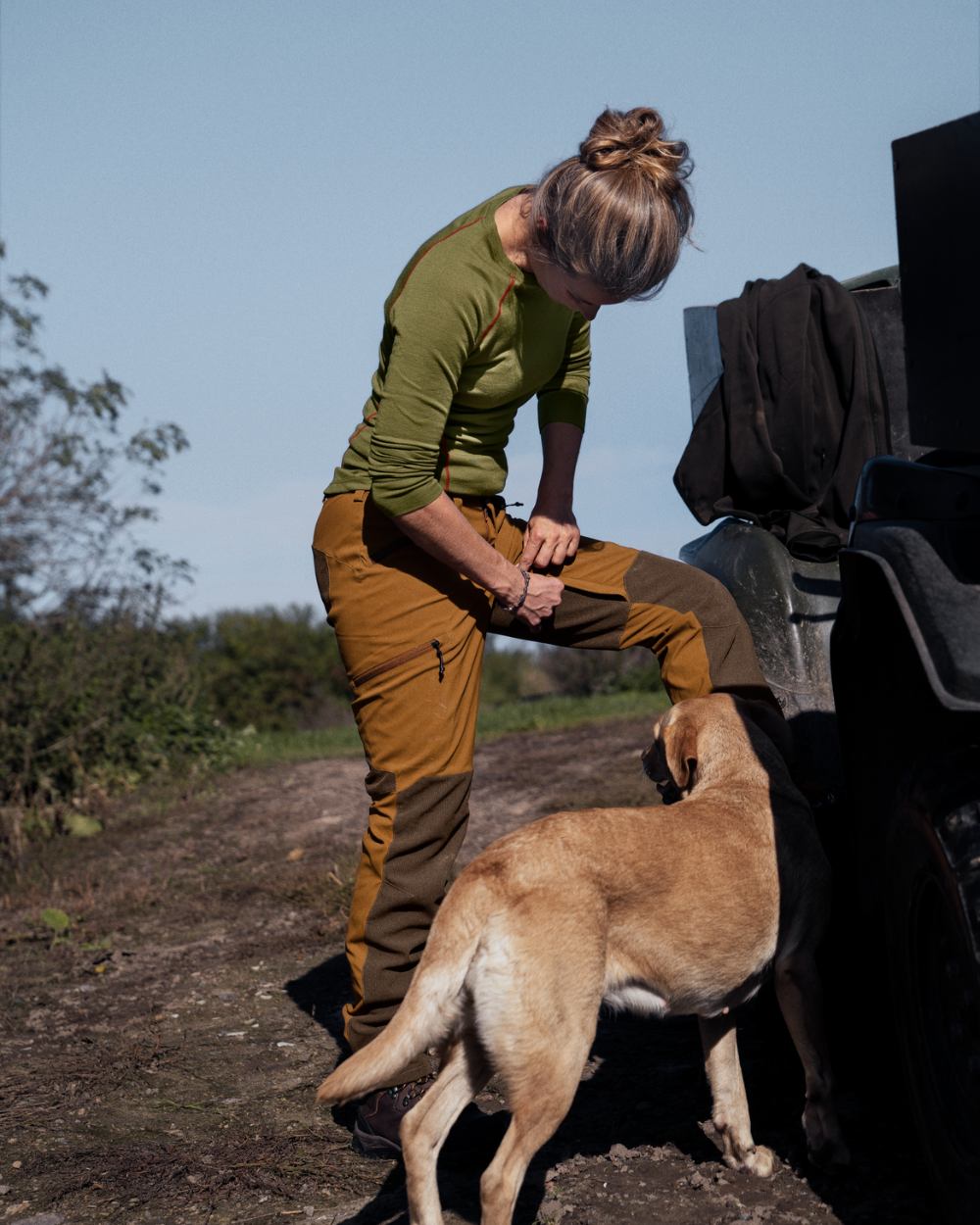 Burnt Clay Coloured Seeland Womens Larch Membrane Waterproof Trousers On A Forest Background 