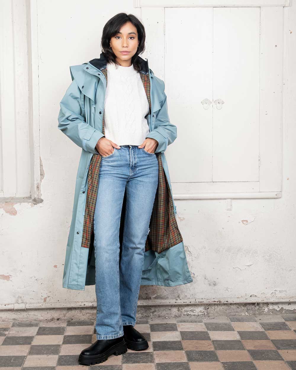 Smokey Blue coloured Jack Murphy Malvern Ladies Waterproof Bush Coat on wall background 