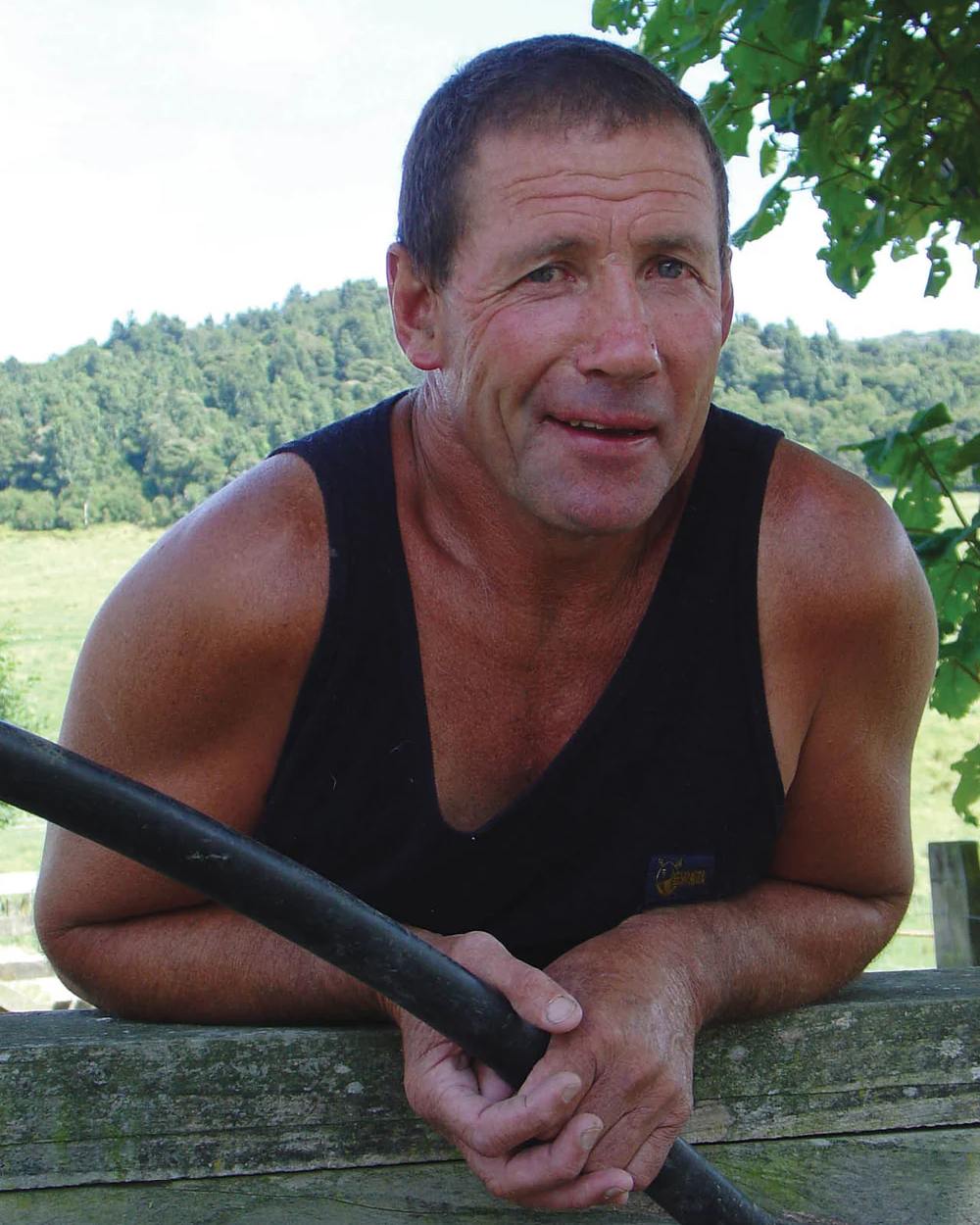 Black Coloured Swazi Micro Fleece Singlet On A Forest Background