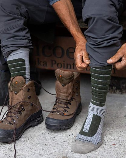 Olive Coloured Swazi The Ibex Socks On A House Background